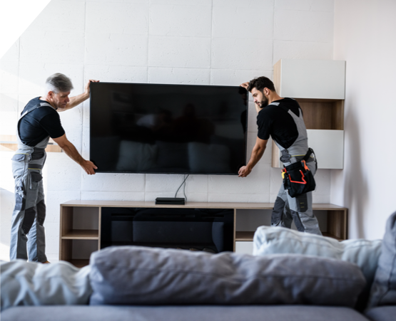 two men mounting tv onto wall